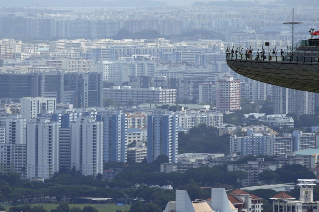 People look out from the observation tower of Marina Bay Sands at public and private residential buildings in Singapore. Photo: Reuters/Edgar Su
