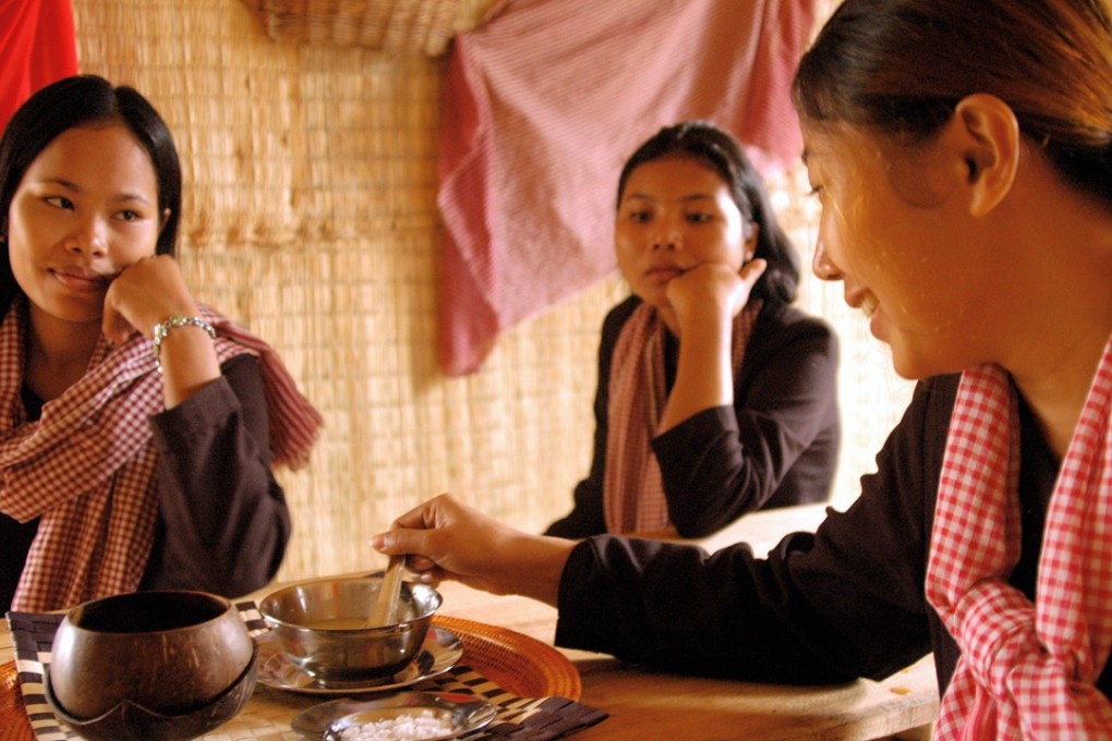 Cambodian waitresses at the History Cafe opposite the Toul Sleng Genocide Museum in Phnom Penh. They wear the red-and-white scarves favoured by Pol Pot's Khmer Rouge regime. Photo: AFP