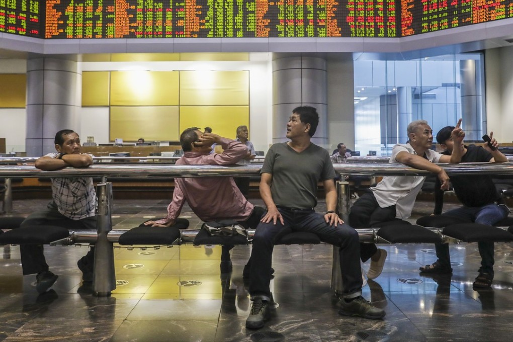 Investors at a private stock market gallery in Kuala Lumpur, Malaysia. Photo: EPA