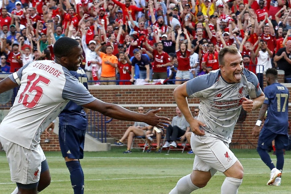 Liverpool’s Xherdan Shaqiri (right) wheels away after scoring the pick of his team’s goals in the thrashing of the Manchester United in Michigan. Photo: AFP