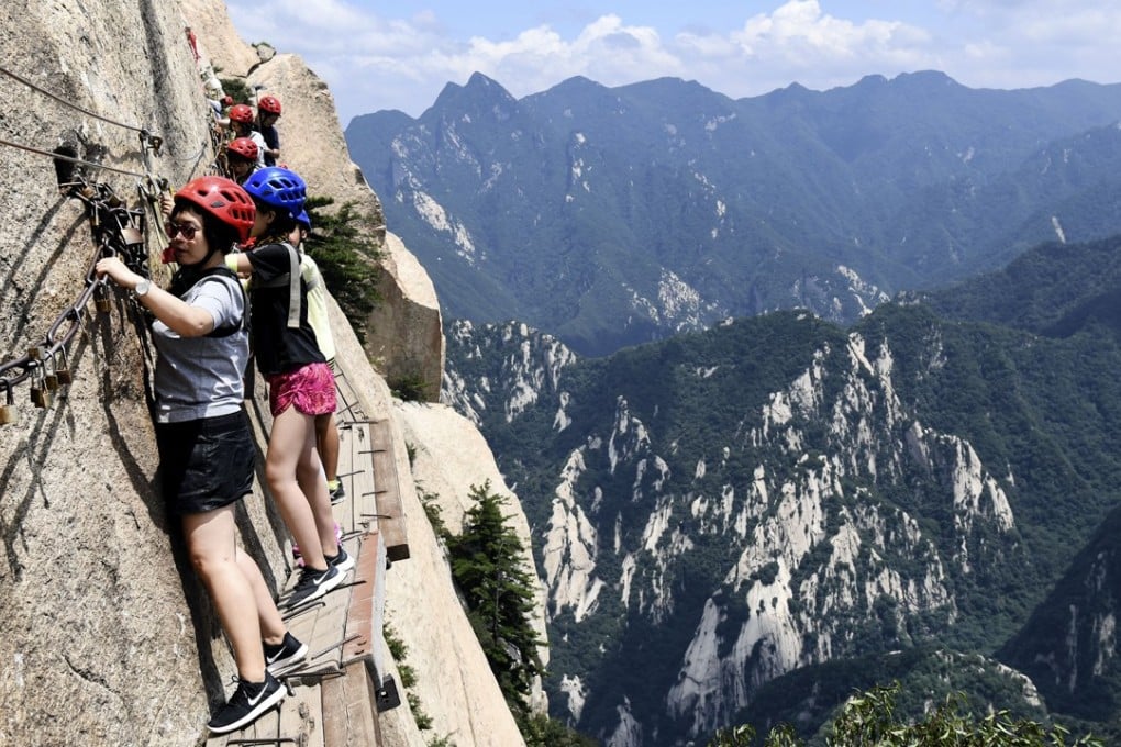 Visitors make their way along the narrow path on Huashan’s southern peak. Photo: Xinhua