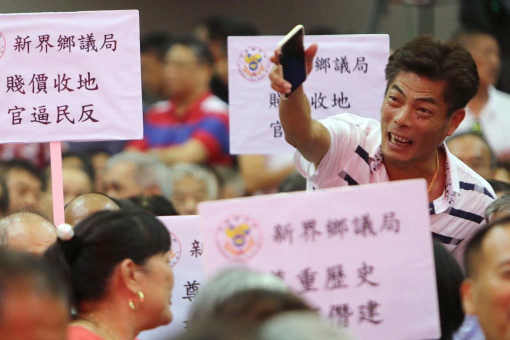 Members held placards and shouted slogans during Monday’s meeting. Photo: Winson Wong