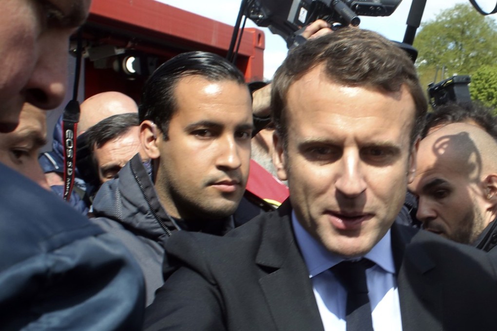 In this April 26, 2017 file photo, Emmanuel Macron, right, is flanked by his bodyguard, Alexandre Benalla, left background, in Amiens, northern France. Photo: AP