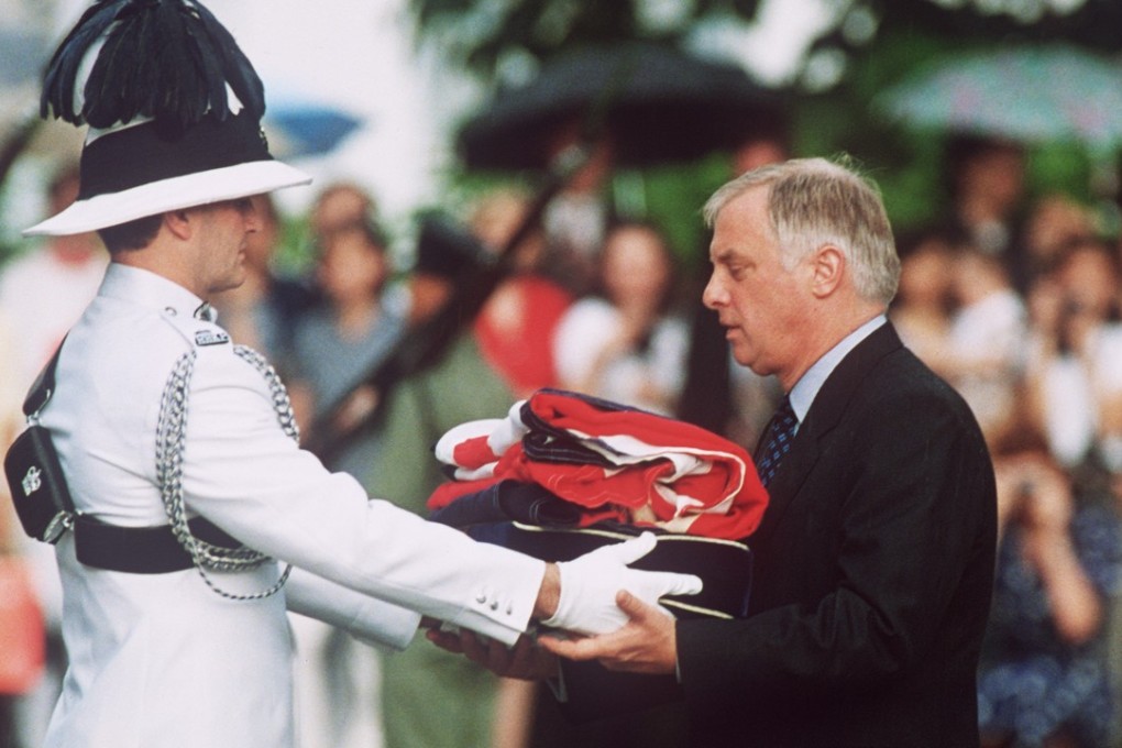 Chris Patten, the last governor of colonial Hong Kong, receives the Union Flag after it was lowered for the last time at Government House on June 30, 1997. Photo: AFP