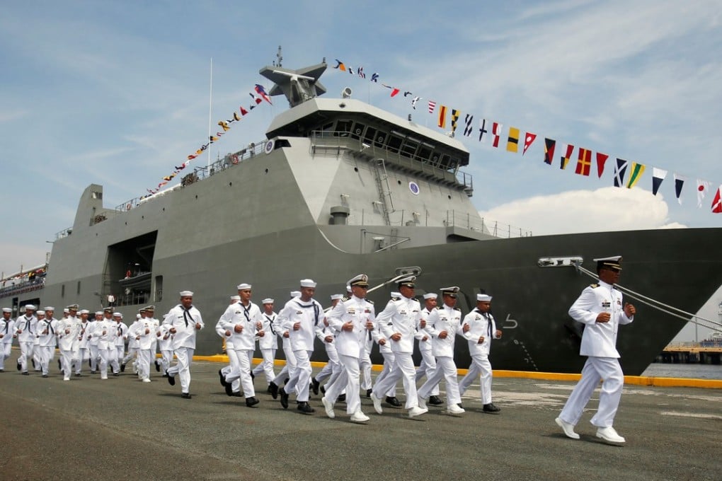 Members of the Philippine navy run past a warship during a 2016 ceremony. Photo: Reuters