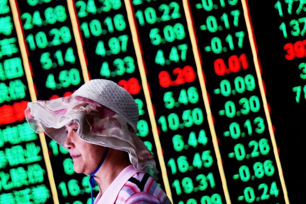 An investor walks past a screen at a securities company in Hangzhou, Zhejiang province. The closure of the dubious WeChat accounts comes during a prolonged slump in the Chinese stock market. Photo: AFP