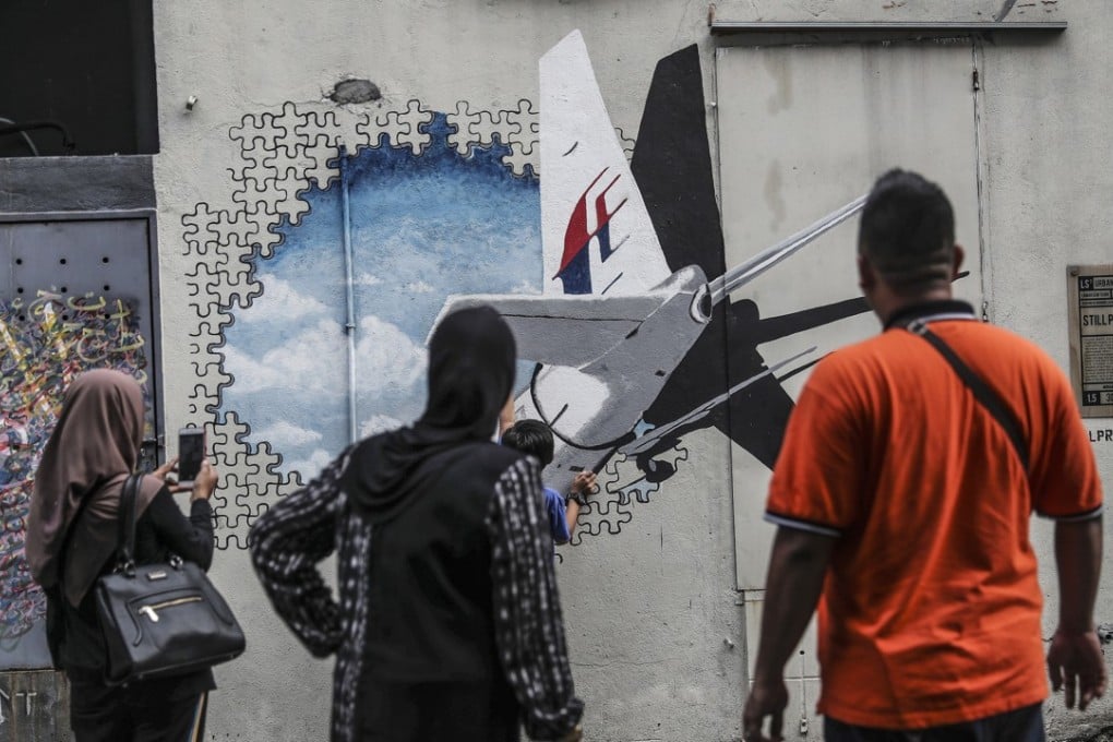 Street art featuring Malaysia Airlines flight MH370 on a wall outside Kuala Lumpur, Malaysia. Photo: EPA
