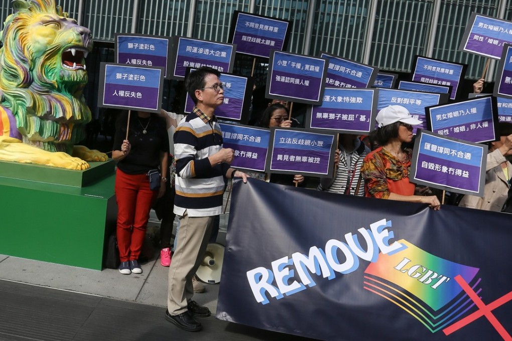 An anti-LGBT concern group protests outside the HSBC headquarters after the bank’s signature lions were dressed in rainbow colours to support gay rights, in Central in December 2016. Photo: Jonathan Wong