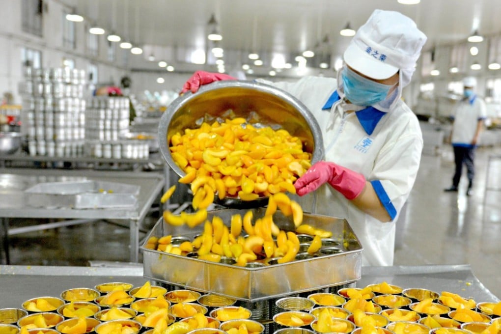 A worker sorting canned peaches for export at a factory in Xiayi, Henan province. China’s total 2017 exports of fruit jams and jellies to America amounted to a total of US$4.1 million. Photo: AFP