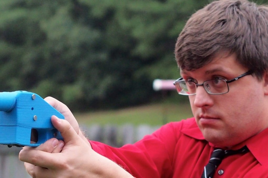 Software engineer Travis Lerol takes aim with an unloaded Liberator handgun in the backyard of his home. File photo: AFP