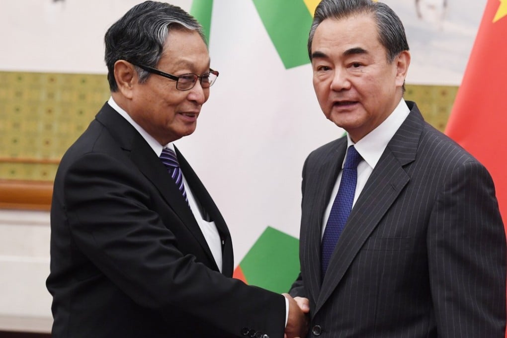 Chinese Foreign Minister Wang Yi (right) shakes hands with Myanmar's Minister for the Office of the State Counsellor Kyaw Tint Swe in Beijing on June 28. Photo: Reuters