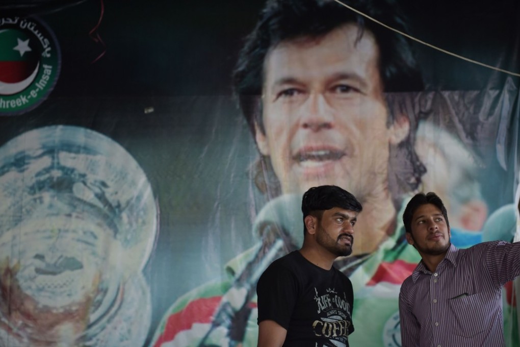 Young Pakistanis take a selfie with a poster of the 1992 World Cup cricket hero now poised to be prime minister, Imran Khan, in the capital Islamabad on July 30. Running the country will take considerable statecraft from Khan's relatively inexperienced party, though he brings charisma and international name recognition, and won a sizeable though not outright majority in the July 25 election. Photo: AFP