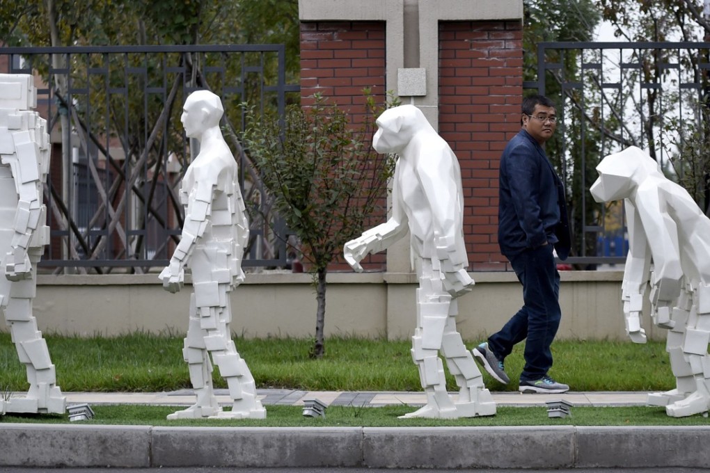 A man walks past sculptures outside Xianghe Robot Industry Port in China’s Hebei province in October 2017. The Made in China 2025 plan has ruffled feathers in the West, but it will take a commitment of time, talent and money for the country to become a true technology leader. Photo: AFP