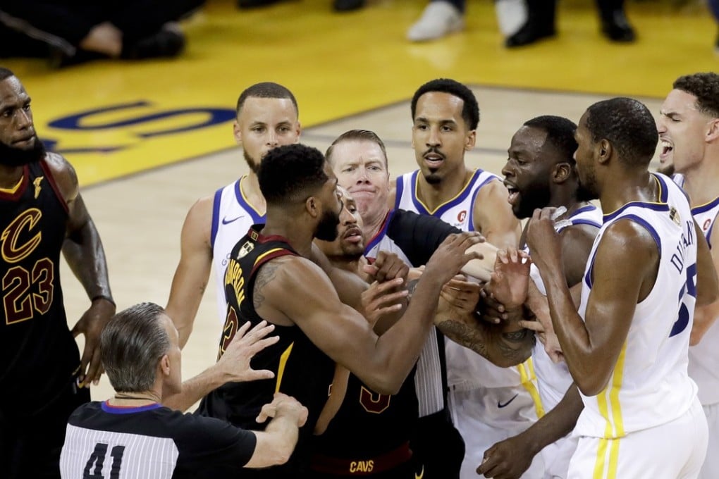 An official tries to separate Tristan Thompson and Draymond Green during overtime of game one of the 2018 NBA Finals. Photo: AP
