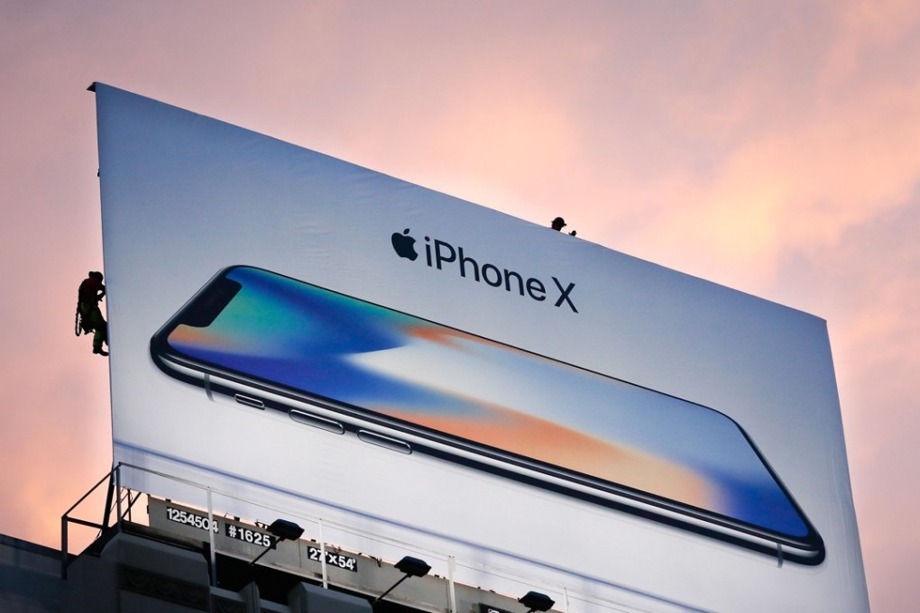Workers finish putting up a new iPhone X billboard above Union Square in advance of the iPhone X launch in San Francisco, California. AFP PHOTO