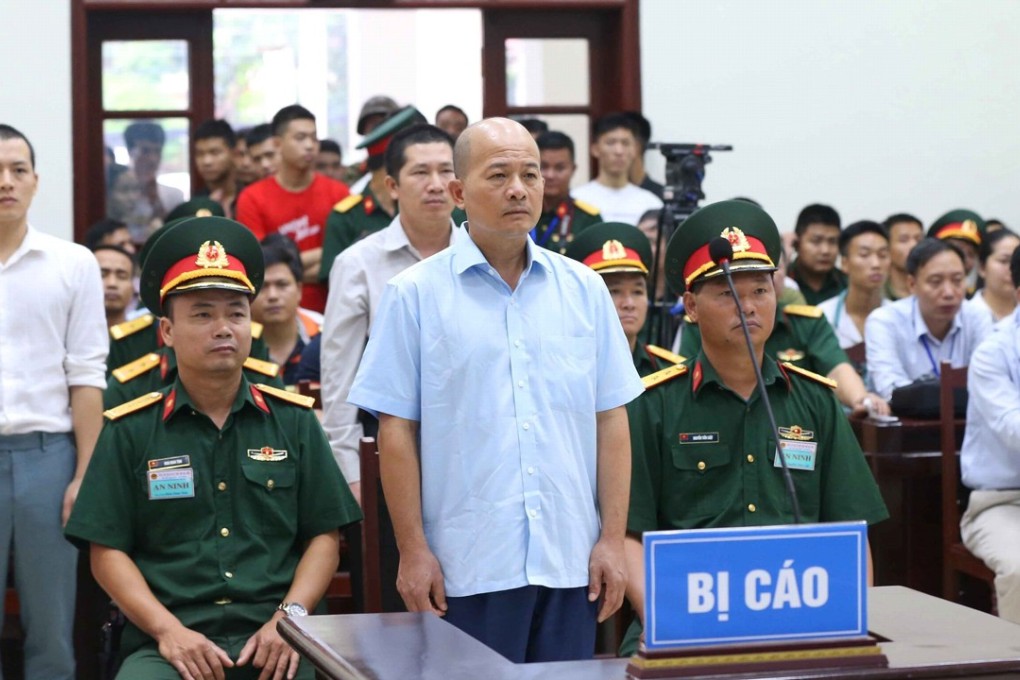 Dinh Ngoc He (centre), a former Vietnamese colonel known by his nickname ‘Little Baldy’, listens during the verdict session of his trial at a military court on Tuesday in Hanoi. Photo: Doan Tan/VNA via Reuters