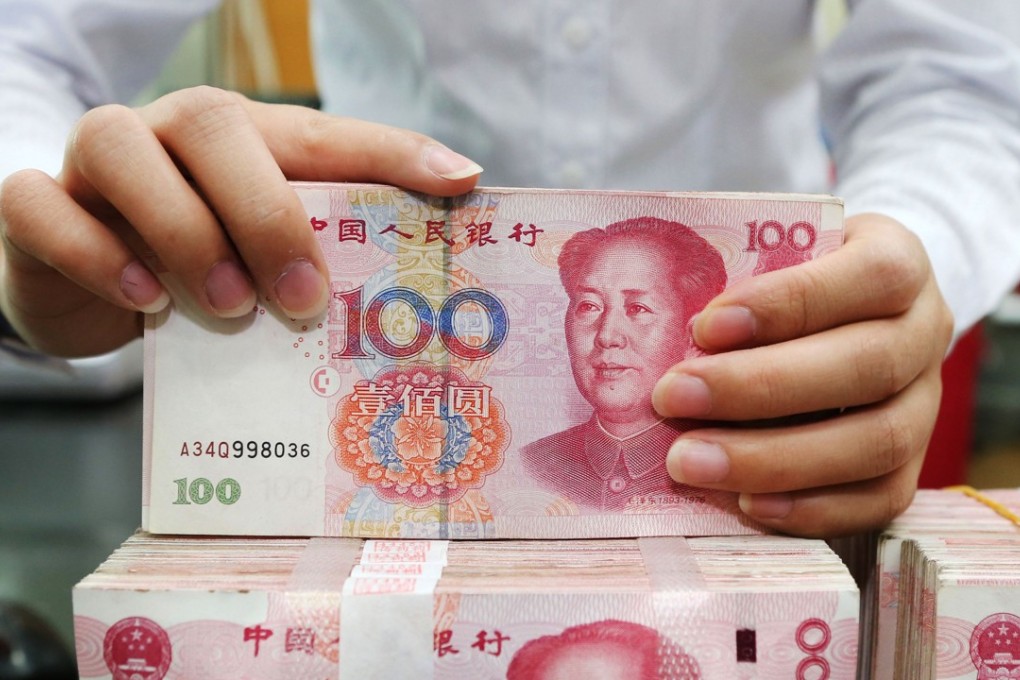 An employee counts 100-yuan notes at a bank in Nantong in China's eastern Jiangsu province on July 23, the day China rejected accusations by US President Donald Trump that it was manipulating the yuan to give its exporters an edge. Photo: AFP