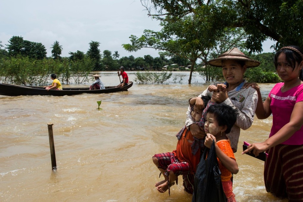 Residents make their way in floodwaters in Shwegyin, in the Bago region of Myanmar. Photo: AFP