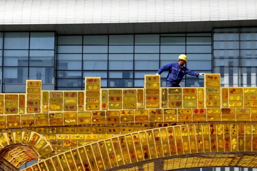 A worker walks on a structure representing the “golden bridge of the Silk Road” on display outside the National Convention Centre, the venue of the Belt and Road Forum for International Cooperation, in Beijing in April 2017. The US has sought to counter China’s ambitious Belt and Road Initiative with the Indo-Pacific Business Forum launched this week. Photo: AP