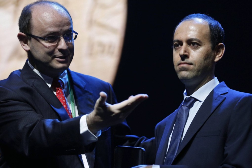 Cambridge University professor Caucher Birkar (right) receives the Fields medal at a ceremony in Rio de Janeiro, Brazil, on Wednesday. The award was stolen minutes later. Photo: EPA-EFE