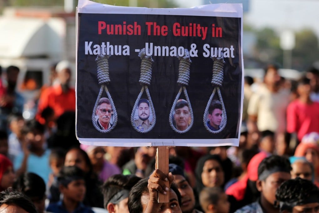 People hold placards at a protest against the rape of an eight-year-old girl, in Kathua, in the Indian state of Jammu and Kashmir, a teenager in Unnao, Uttar Pradesh state, and an 11-year-old girl in Surat in Gujarat state at a demonstration in Ahmedabad on April 22. Photo: Reuters