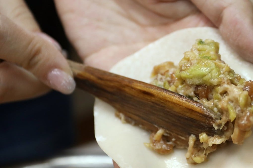 Abalone, asparagus and pork dumplings – a nod to Hong Kong tastes – are put together at Northern Dumpling Yuan in Wan Chai. Photo: Tory Ho