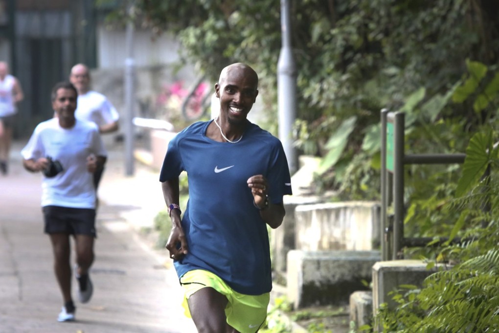 Sir Mohamed Muktar Jama “Mo” Farah jogs with supporters on Bowen Road in 2017. Bowen Road is a great option to keep training in the heat. Photo: Jonathan Wong