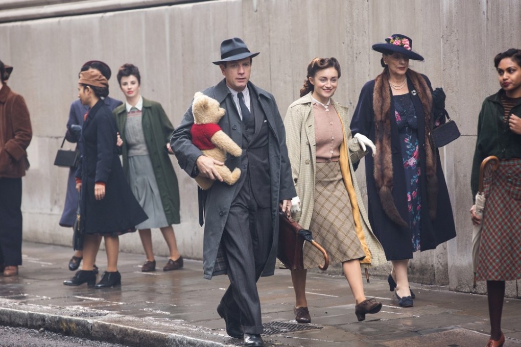 Christopher Robin (Ewan McGregor) walks down a London street with his childhood companion Winnie the Pooh in the Disney movie Christopher Robin (category I), directed by Marc Forster. Hayley Atwell and Bronte Carmichael co-star.