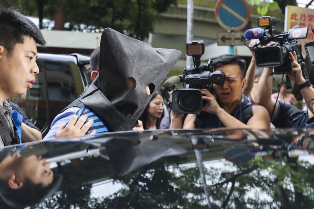 Hong Kong police lead away a 30-year-old suspect over needles left sticking out of bus seats, in Tsing Yi on July 5. Photo: Winson Wong
