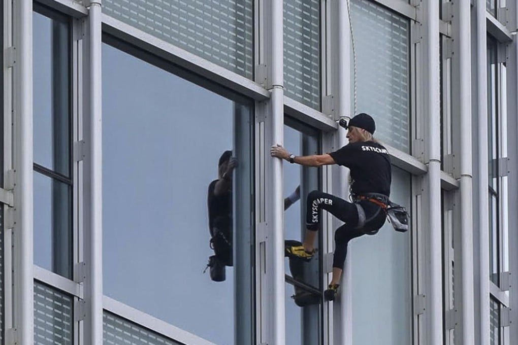 Alain Robert scales the Four Seasons Hotel in Central. Photo: Handout