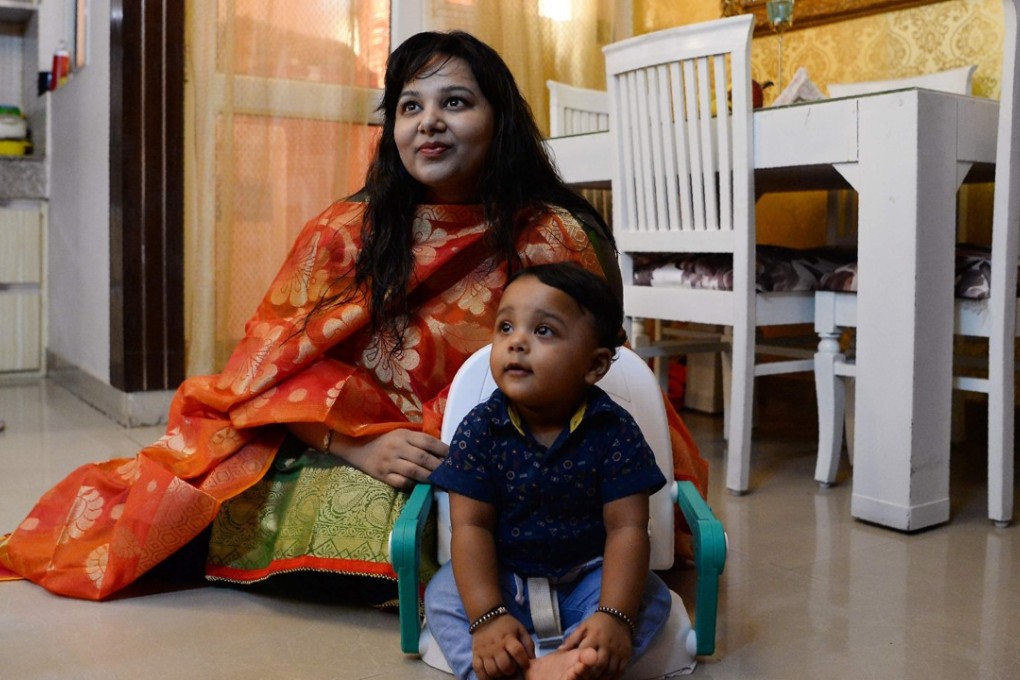 Neha Rastogi with her nine-month-old son. Photo: AFP