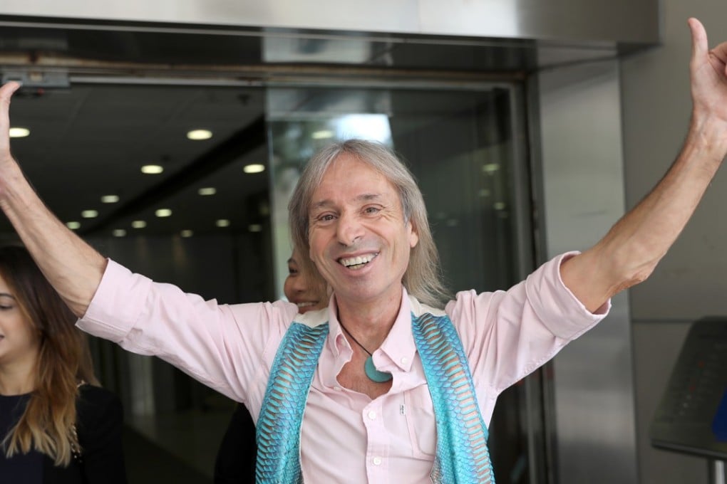 Alain Robert leaves Eastern Court after being barred from climbing buildings in Hong Kong for a year. Photo: Edward Wong