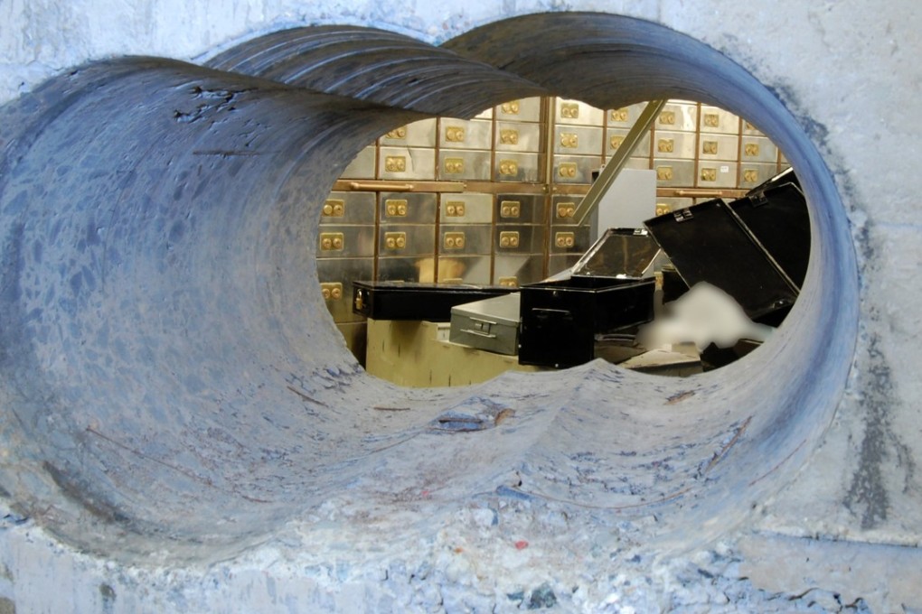 The hole thieves drilled through a concrete wall half a metre thick at an underground safe deposit centre in Hatton Garden, London, in 2015 through which they stole an estimated £200 million worth of diamonds and jewellery. Photo: AFP