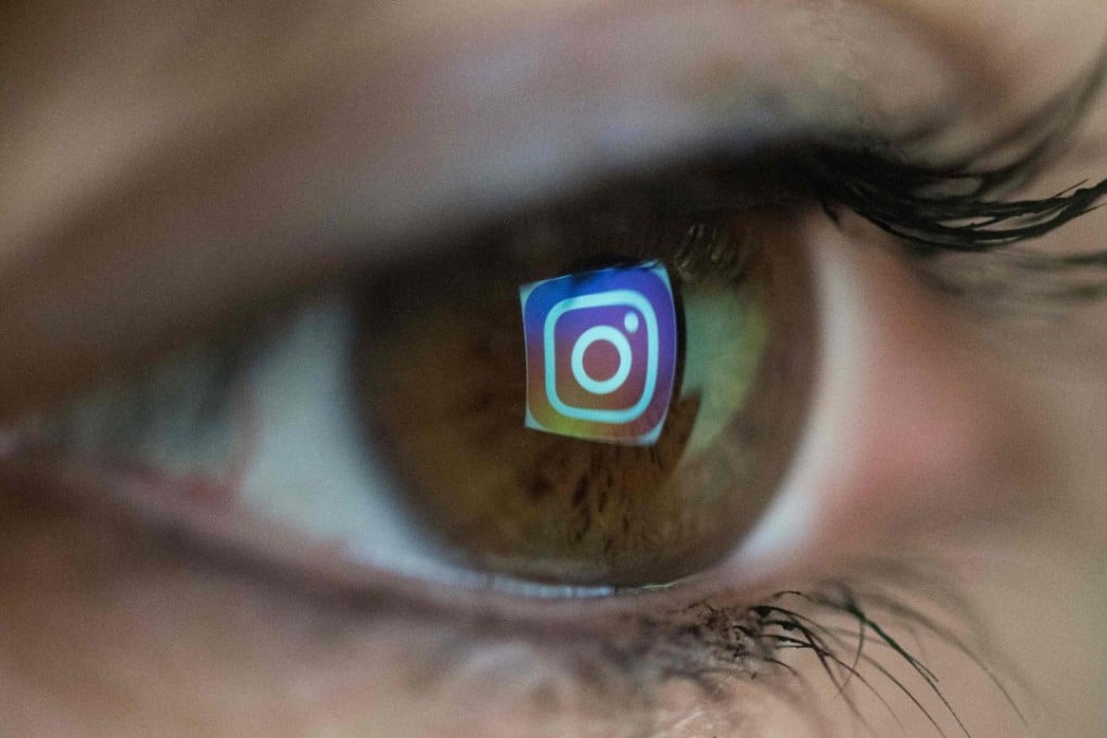 A reflection of the Instagram logo in the eye of a user. Both Facebook and Instagram are introducing measures to help reduce the time people spend on their apps. Photo: AFP