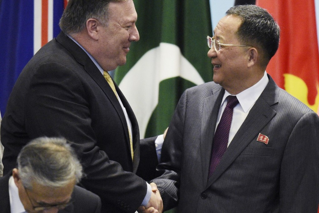 US Secretary of State Mike Pompeo greets North Korea’s Foreign Minister Ri Yong-ho as they prepare for a group photo at the Asean summit in Singapore on Saturday. Photo: AP