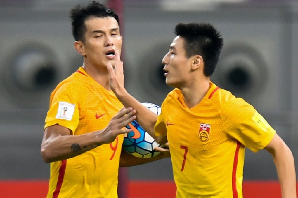 Wu Lei (right) celebrates scoring for China. Photo: Xinhua