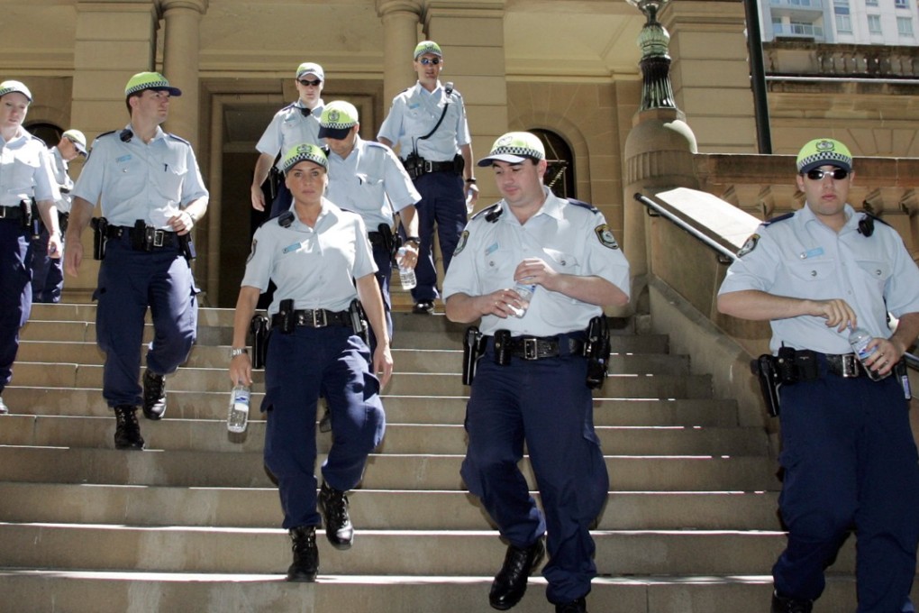 New South Wales police keep watch outside the Central Local Court in Sydney, Friday, Nov 11, 2005. Sydney magistrate Allan Moore adjourned until later Friday a bail hearing for eight Sydney Muslims charged with making explosives to carry out a terror bombing. (AP Photo/Mark Baker)