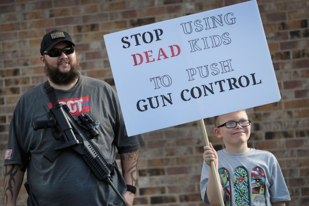 James Everard and his nine-year-old son Steven join a group advocating for the rights of gun owners on March 24 in Killeen, Texas. Photo: Getty Images / AFP