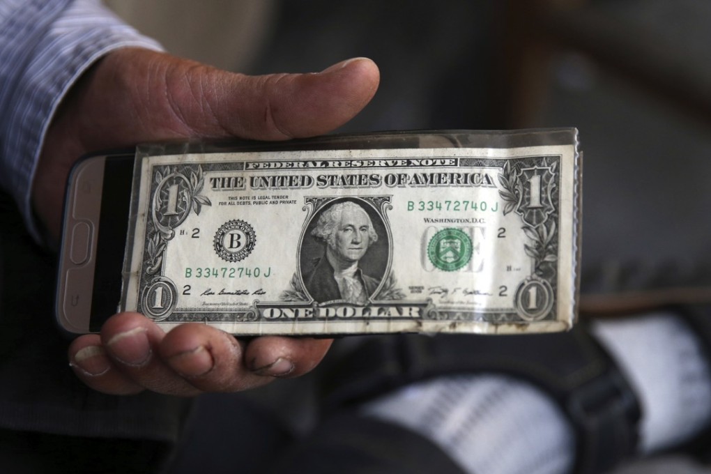 In this July 30, photo, an Iranian street money exchanger holds a US banknote in downtown Tehran, Iran. As the Trump administration readies to re-impose sanctions on Iran, American allies fear greater regional instability. Photo: AP