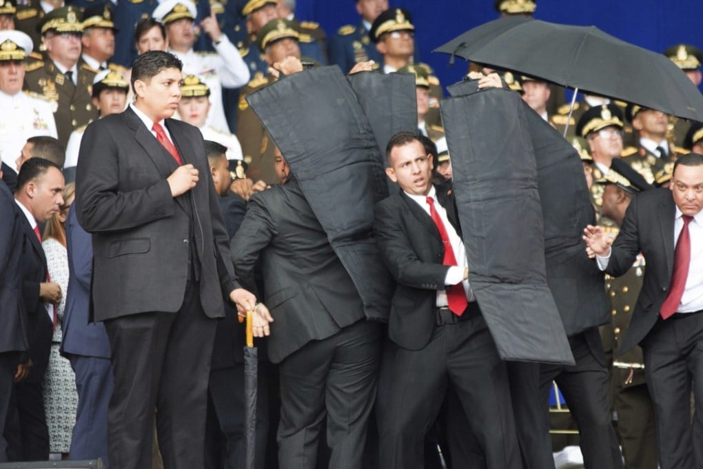 Security personnel surround Venezuela’s President Nicolas Maduro after explosions were heard while he was giving a speech in Caracas on August 4, 2018. Photo: Xinhua