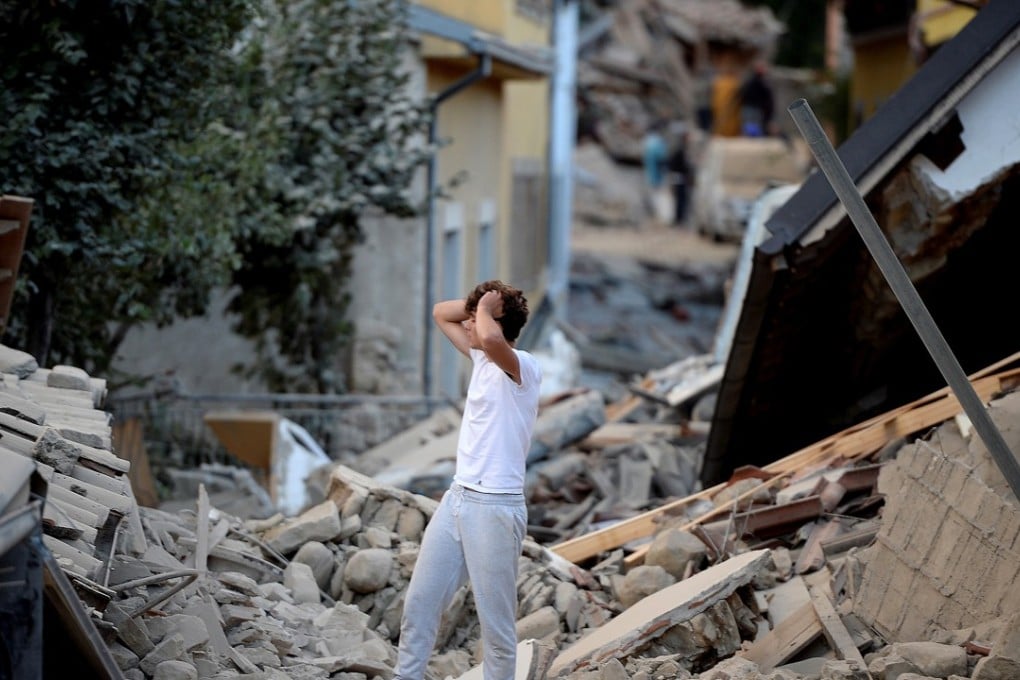 A man stands among damaged buildings after a strong earthquake hit Amatrice in central Italy on August 24, 2016. Photo: AFP