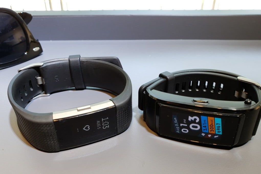 The Huawei TalkBand B5 (right) fitness tracker has a similar look and performance to the Fitbit Charge 2 (left). Photo: Ben Sin