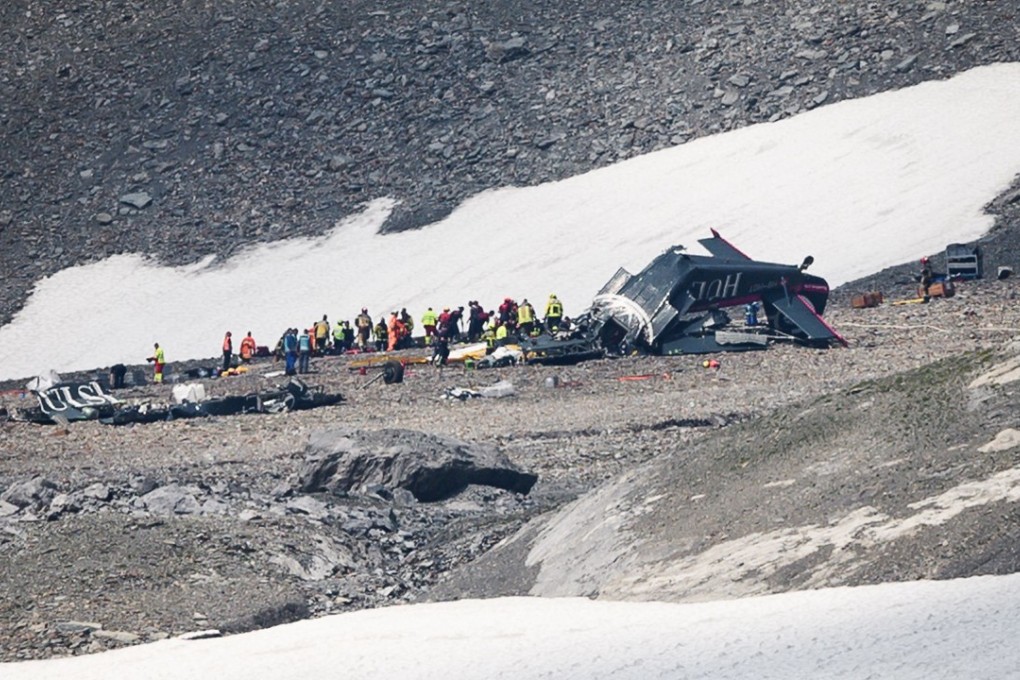Accident investigators and rescue personnel work at the wreckage of a Junkers Ju-52 aircraft in the Swis Alps on Sunday. Photo: Agence France-Presse