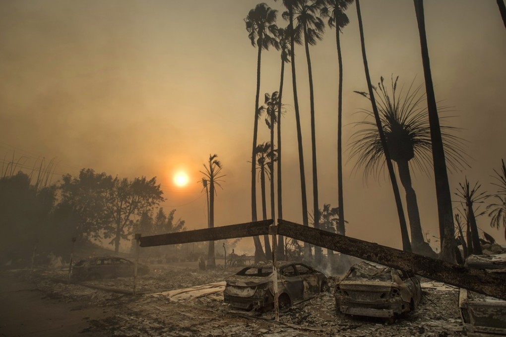 In this December 5, 2017 file photo, smoke rises behind a destroyed apartment complex as a wildfire burns in Ventura, California. Photo: AP