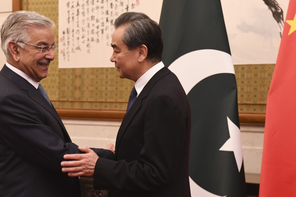 Pakistan’s Foreign Minister Khawaja Muhammad Asif (left) shakes hands with Chinese Foreign Minister Wang Yi at the Diaoyutai State Guest House in Beijing on April 23. Photo: AFP