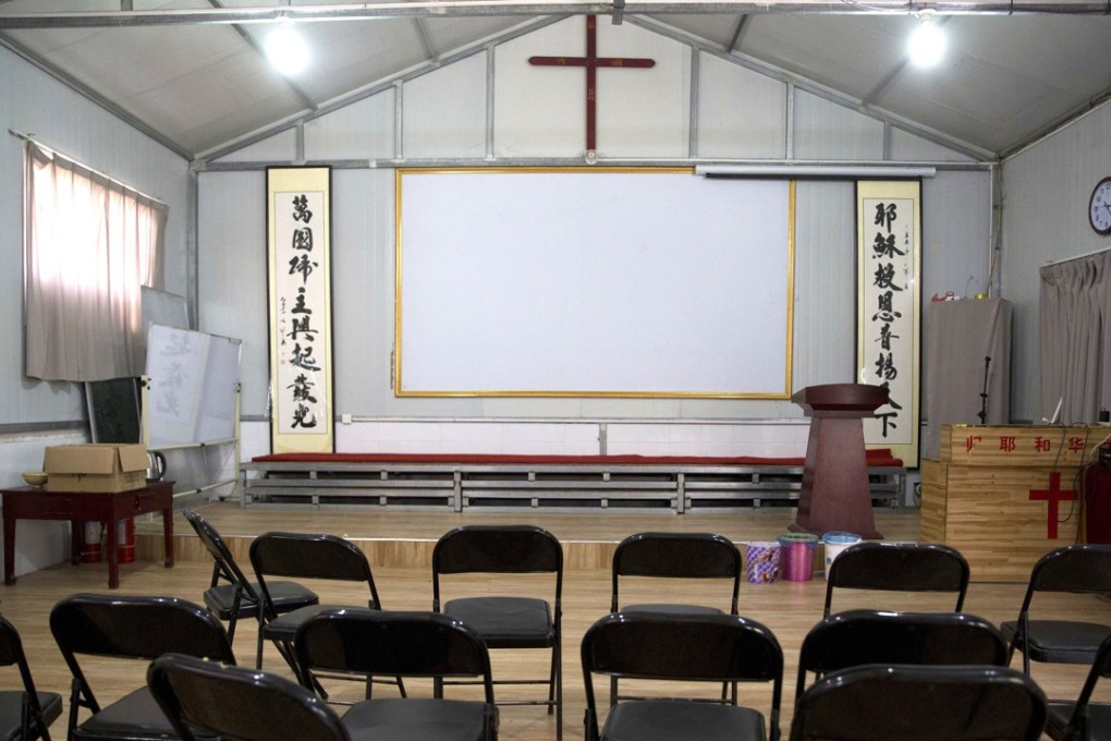 Calligraphy reading “All nations belong to the Lord arising to shine” (left) and “Jesus’ salvation spreads to the whole world” are seen under a crucifix in a “house church” shut down near Nanyang, Henan. Photo: AP