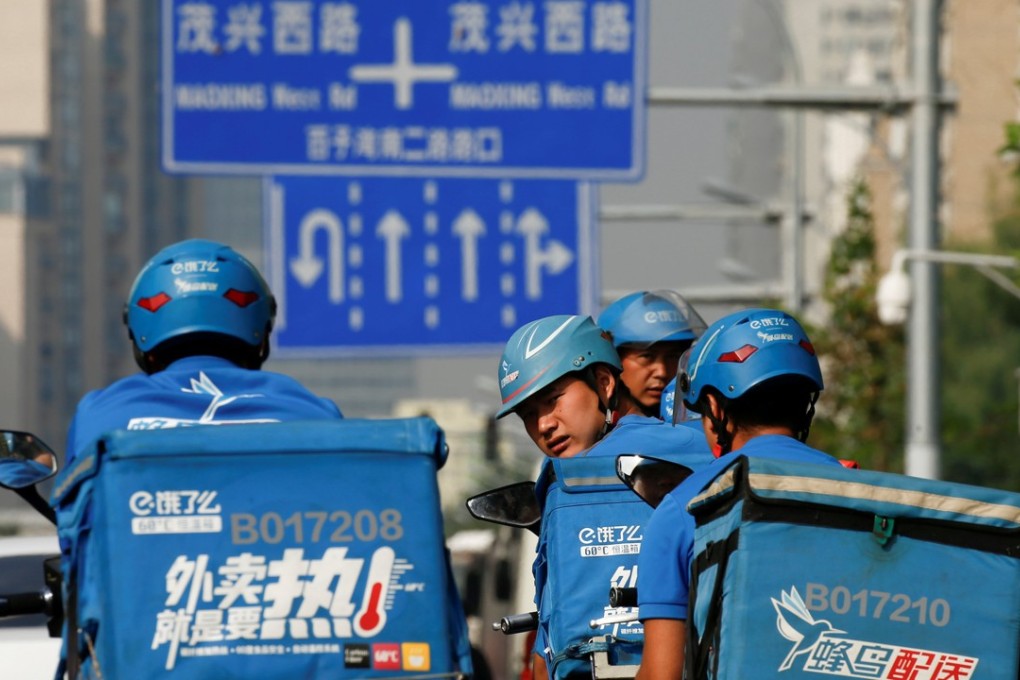 Drivers of the food delivery service Ele.me prepare to start their morning shift. Photo: Reuters