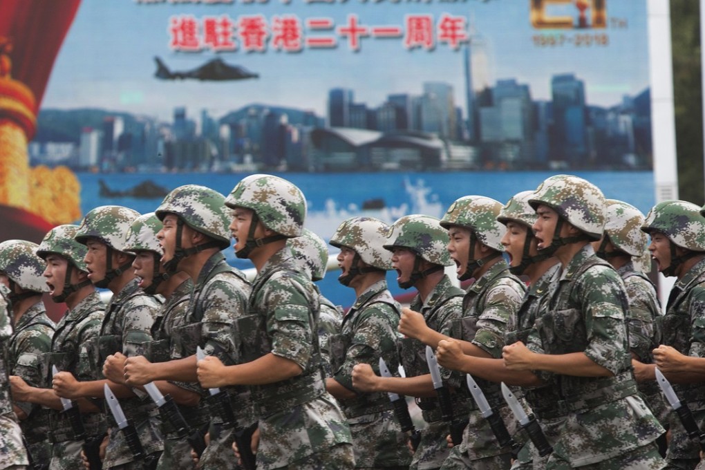 Soldiers demonstrate combat exercises at a PLA barracks open day to mark the 21st anniversary of Hong Kong’s return to China, at the Ngong Shuen Chau naval base in Kowloon, on July 1. Photo: EPA