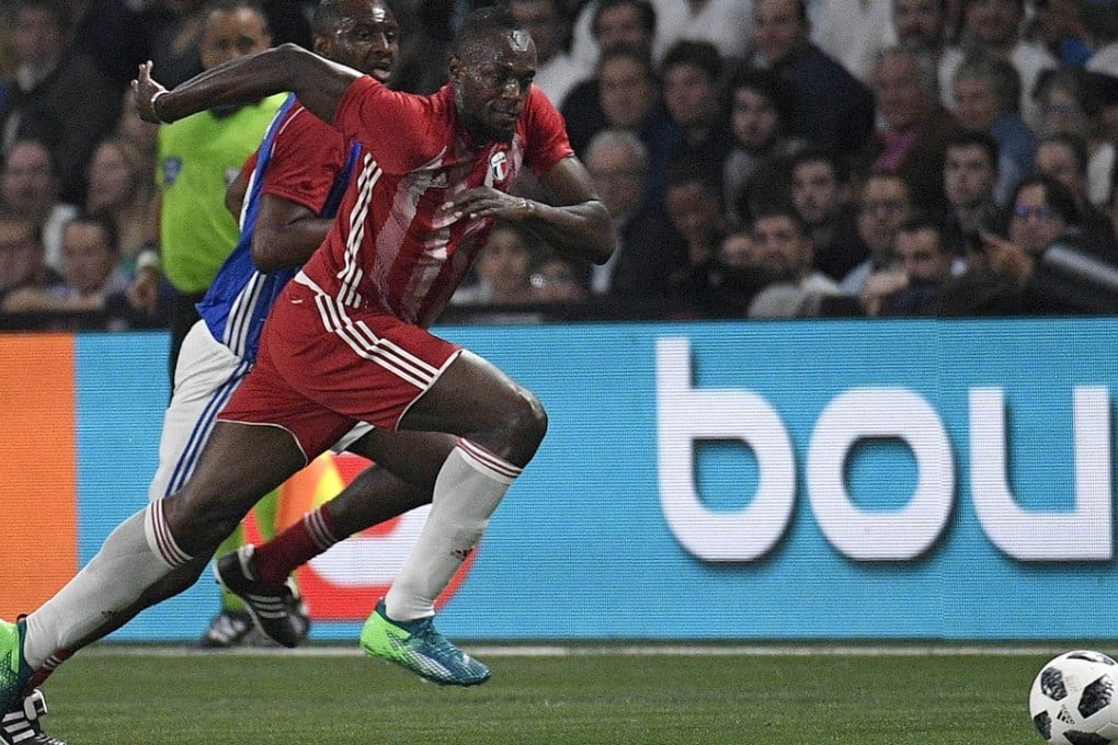 Usain Bolt in action during a friendly match between a selection of French 1998 World Cup winning players and an international selection in June. Photo: EPA-EFE/Herve Ranchin