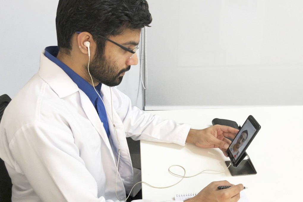 A doctor uses the MFine app to help a patient. The app was created to help users consult doctors from leading hospitals online by phone, text, or video. Photo: MFine